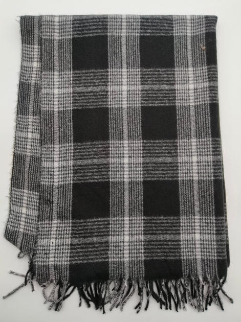 Plaid tissé tartan noir et blanc plié avec finition franges nouées