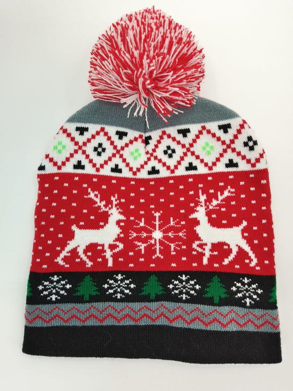 Bonnet de Noël rouge blanc en jacquard avec rennes sapins flocons et pompon rouge blanc sur fond clair